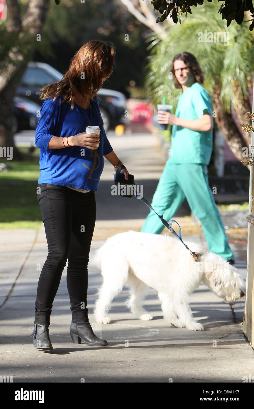 Olivia Wilde Picks Up Her Dog Paco Form A Vets In West Hollywood After Picking Up A Coffee From Starbucks Just Before She Gets To Her Car A Man Presents Her With