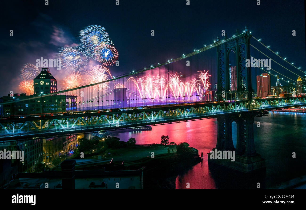 Macy's Fourth of July fireworks seen through Manhattan Bridge, view from Brooklyn rooftop, July 4th, 2014, East River, NYC. Stock Photo