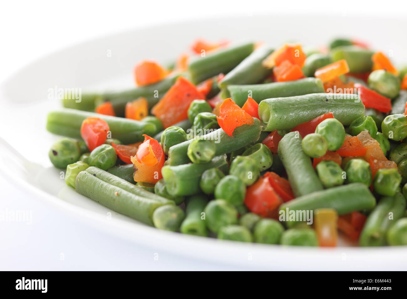 Vegan salad. Ingredients: string beans, green peas, red bell pepper. Closeup. Stock Photo