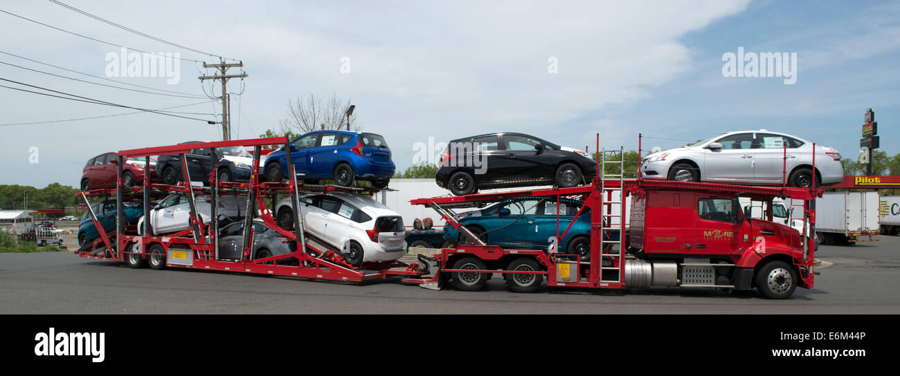 Car carrier  trailer carrying Nissan Versa cars at Pilot Rest Stop in Milford, CT. Stock Photo