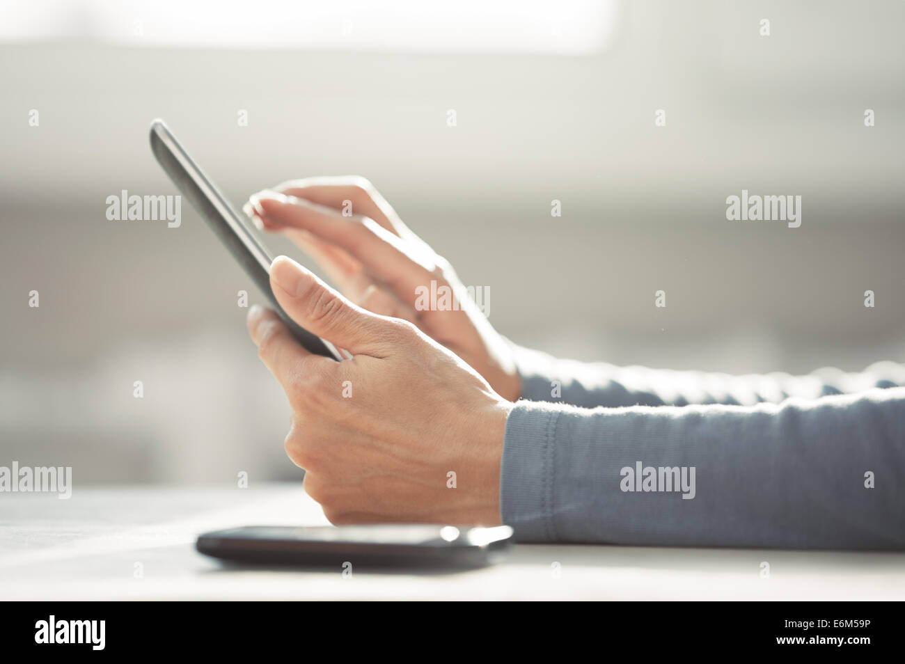 Hands of woman working with digital tablet Stock Photo