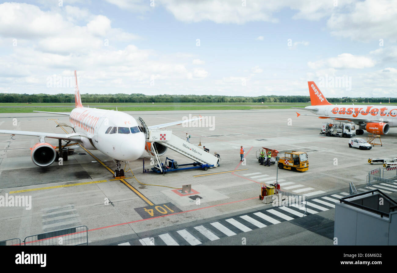 A319 Easy Jet passenger aircraft with travellers boarding at Milan Malpensa airport, Italy. Stock Photo