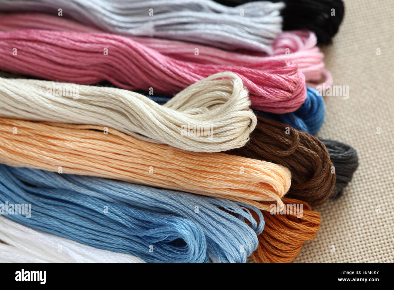 Colorful crossstitch threads on a canvas. Closeup Stock Photo Alamy