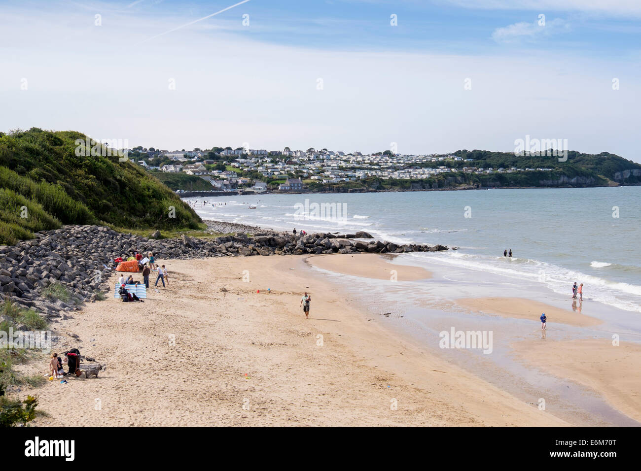 Holidaymakers on dogs allowed zone of sandy beach in summer. Benllech