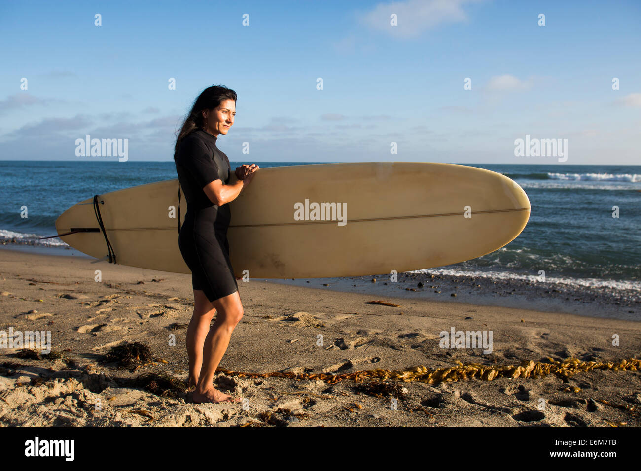 Standing woman holding surfboard hi-res stock photography and images ...