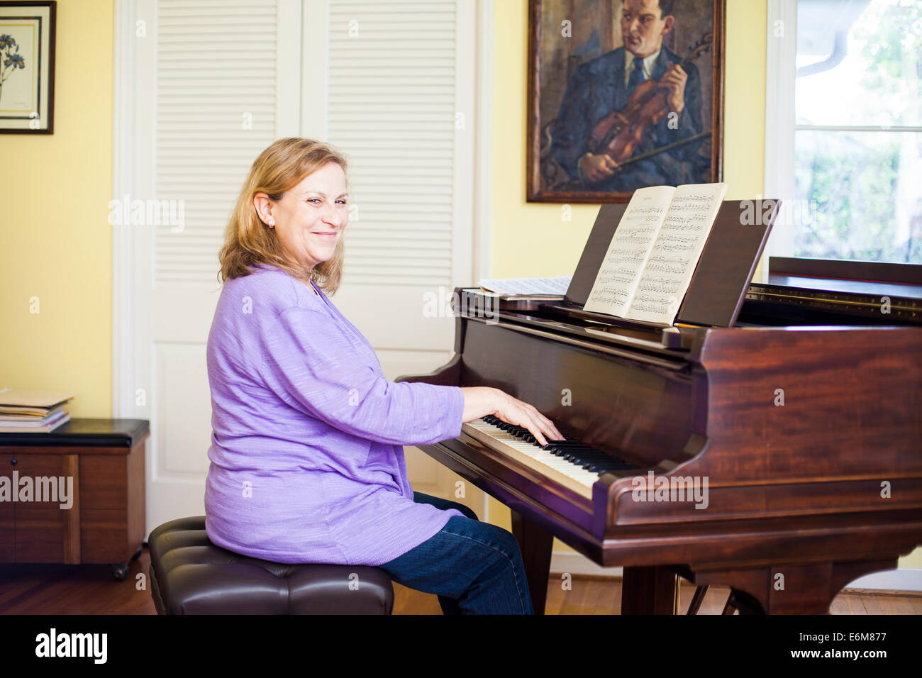 Woman playing piano Stock Photo