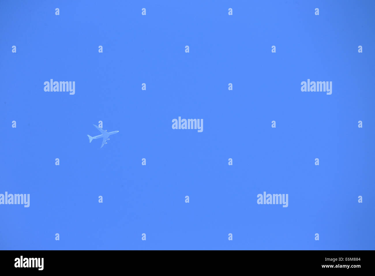 Airplane flying in the blue sky Stock Photo - Alamy