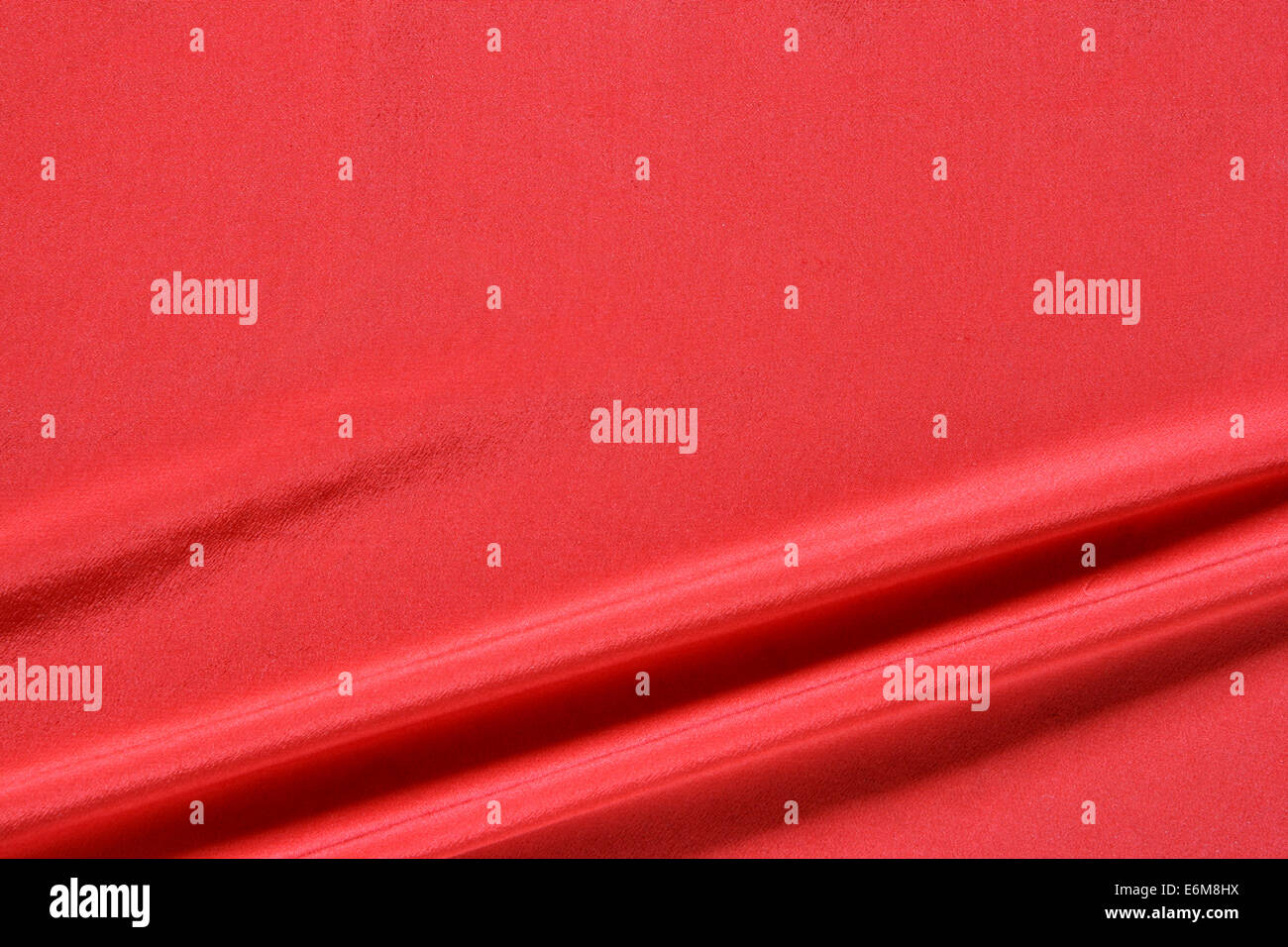 Red fabric background with space for text on top Stock Photo