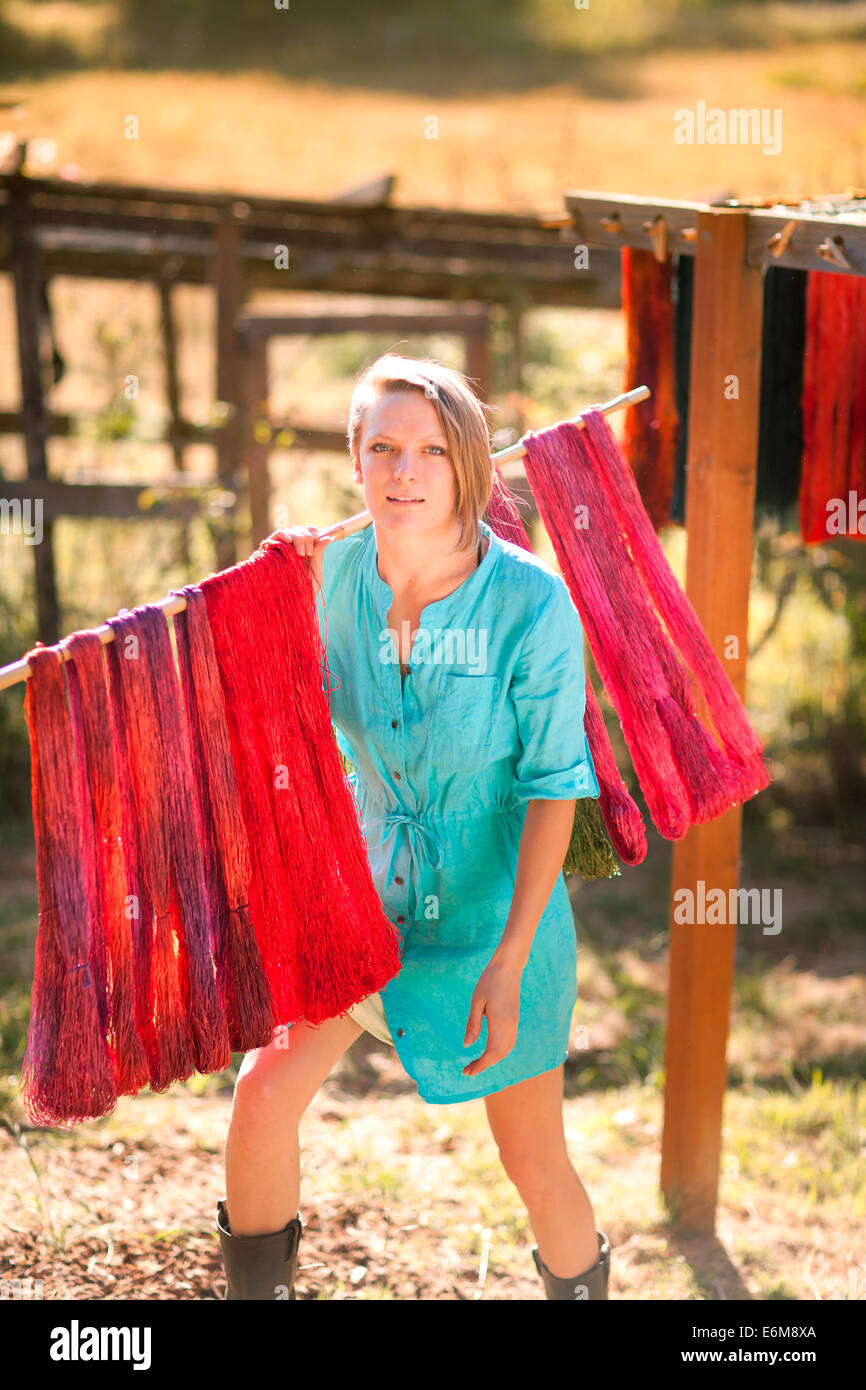 Woman taking away dried yarn Stock Photo