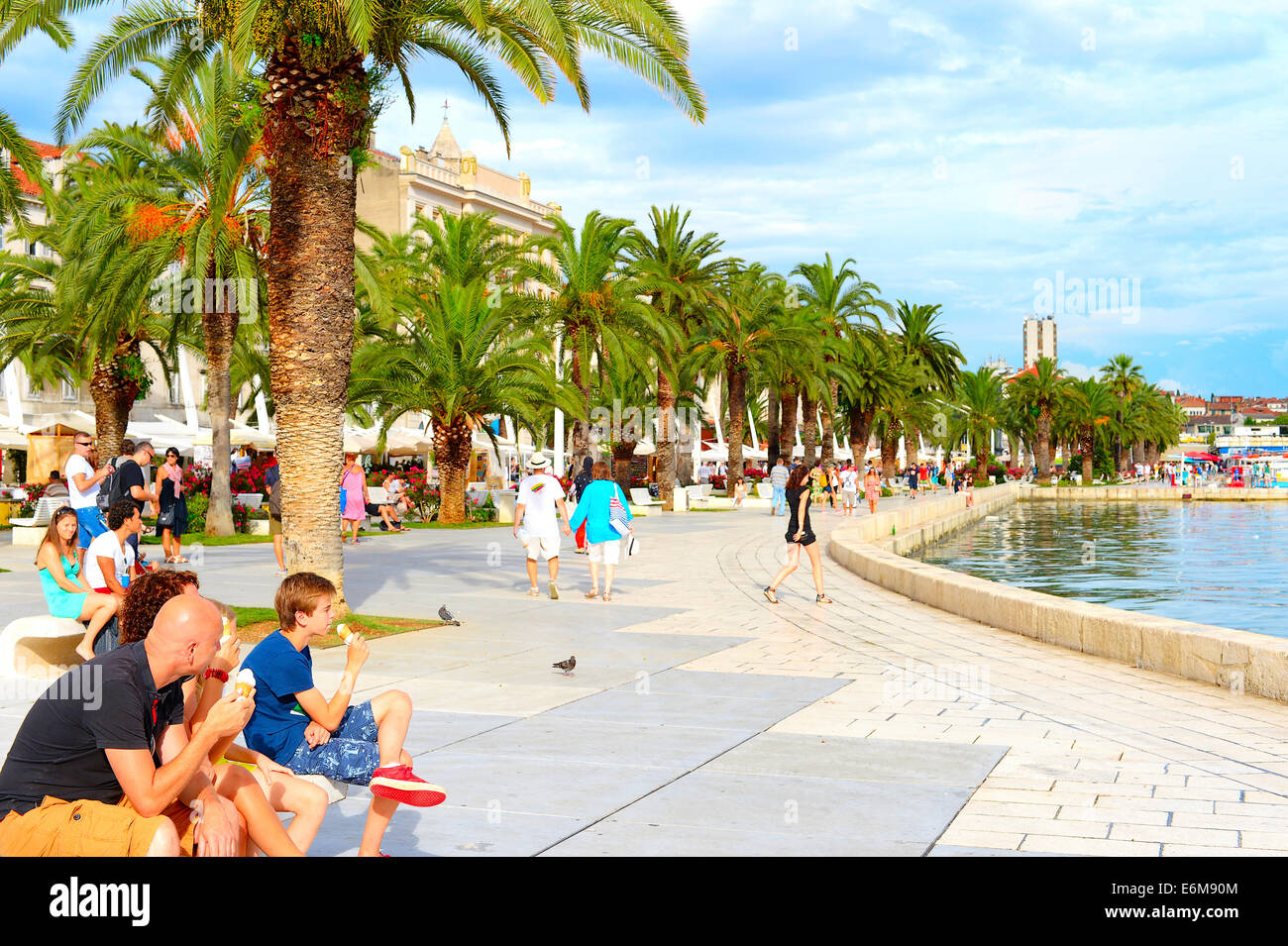 Unidentified people eating ice cream on the embankment of Split. Stock Photo