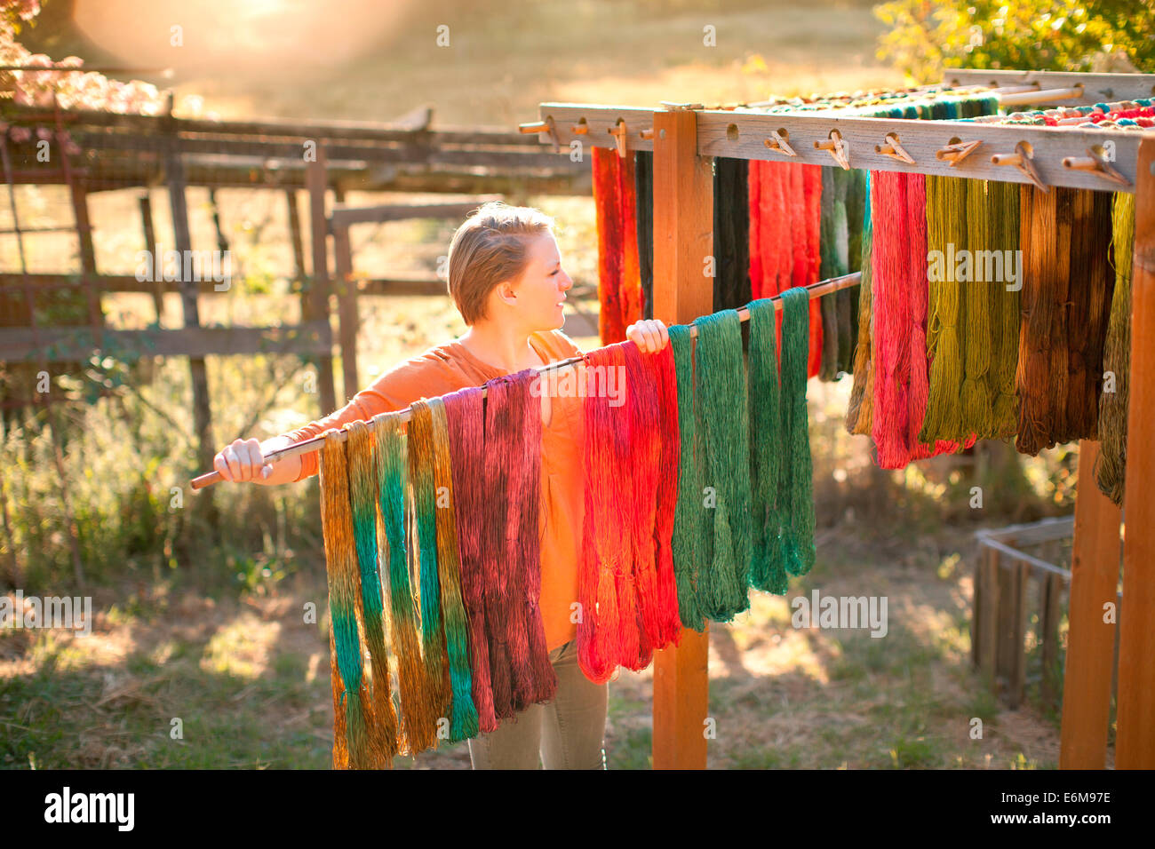 Woman hanging yarn for drying Stock Photo