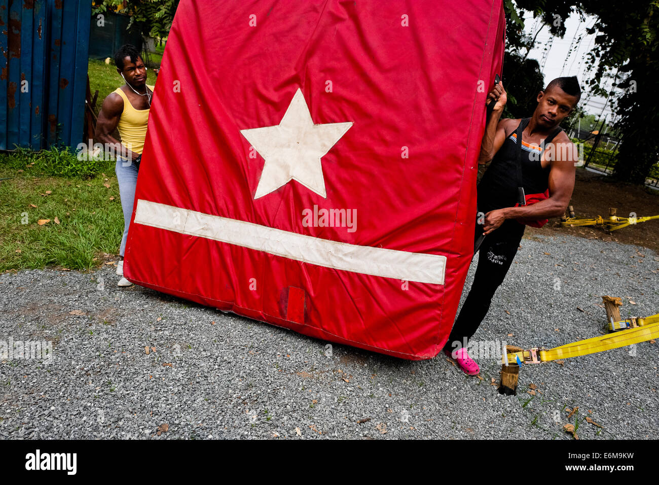 Students carry equipment before the lessons in the circus school Circo para Todos in Cali, Colombia. Stock Photo