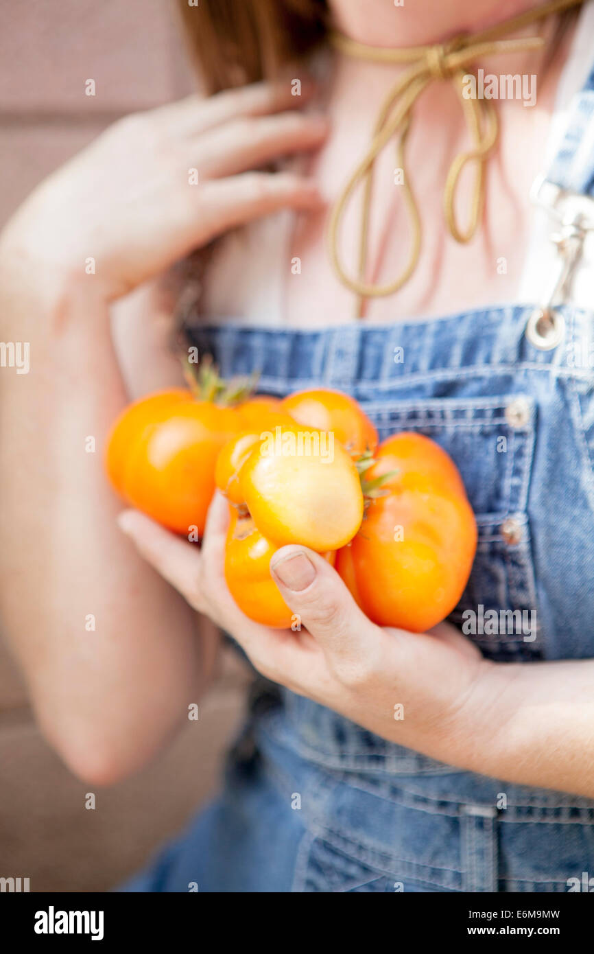 Close-up view of woman holding tomatoes Stock Photo
