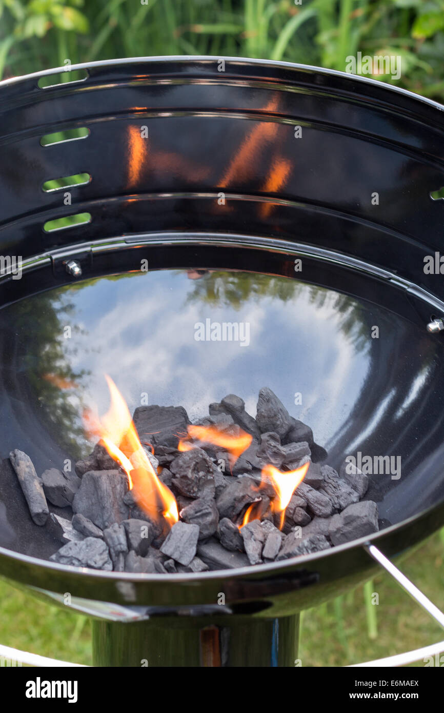 Empty barbecue with charcoal lit up - vertical shot Stock Photo - Alamy