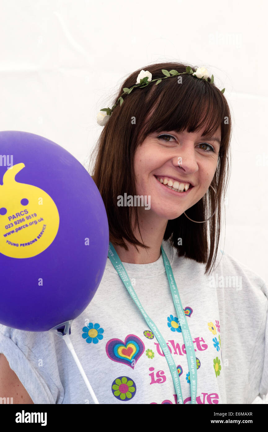 young staff member smiling at her charity stall at the victorious festival 2014 southsea england uk Stock Photo