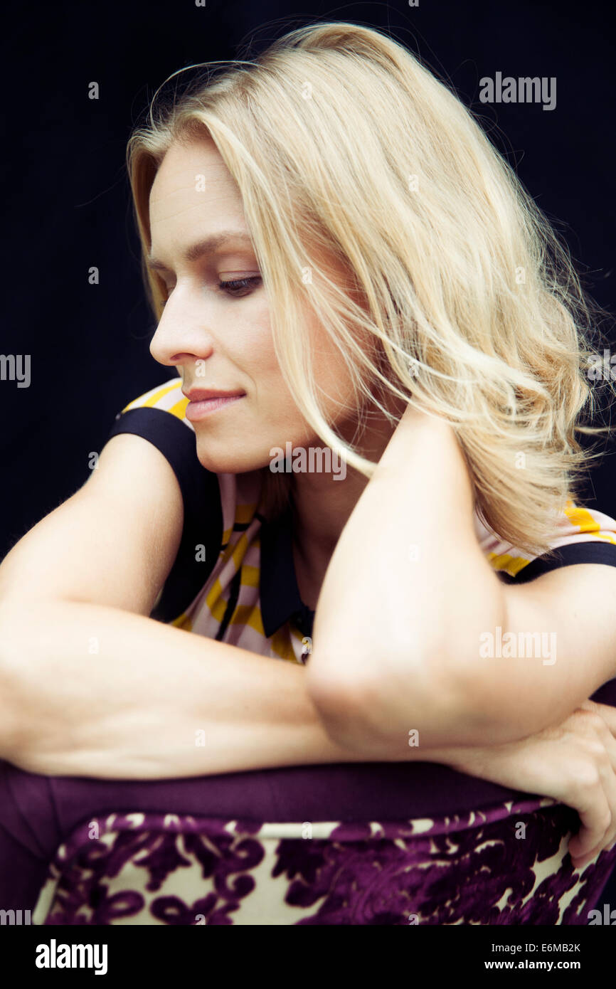 Black woman sitting on chair hi-res stock photography and images - Alamy