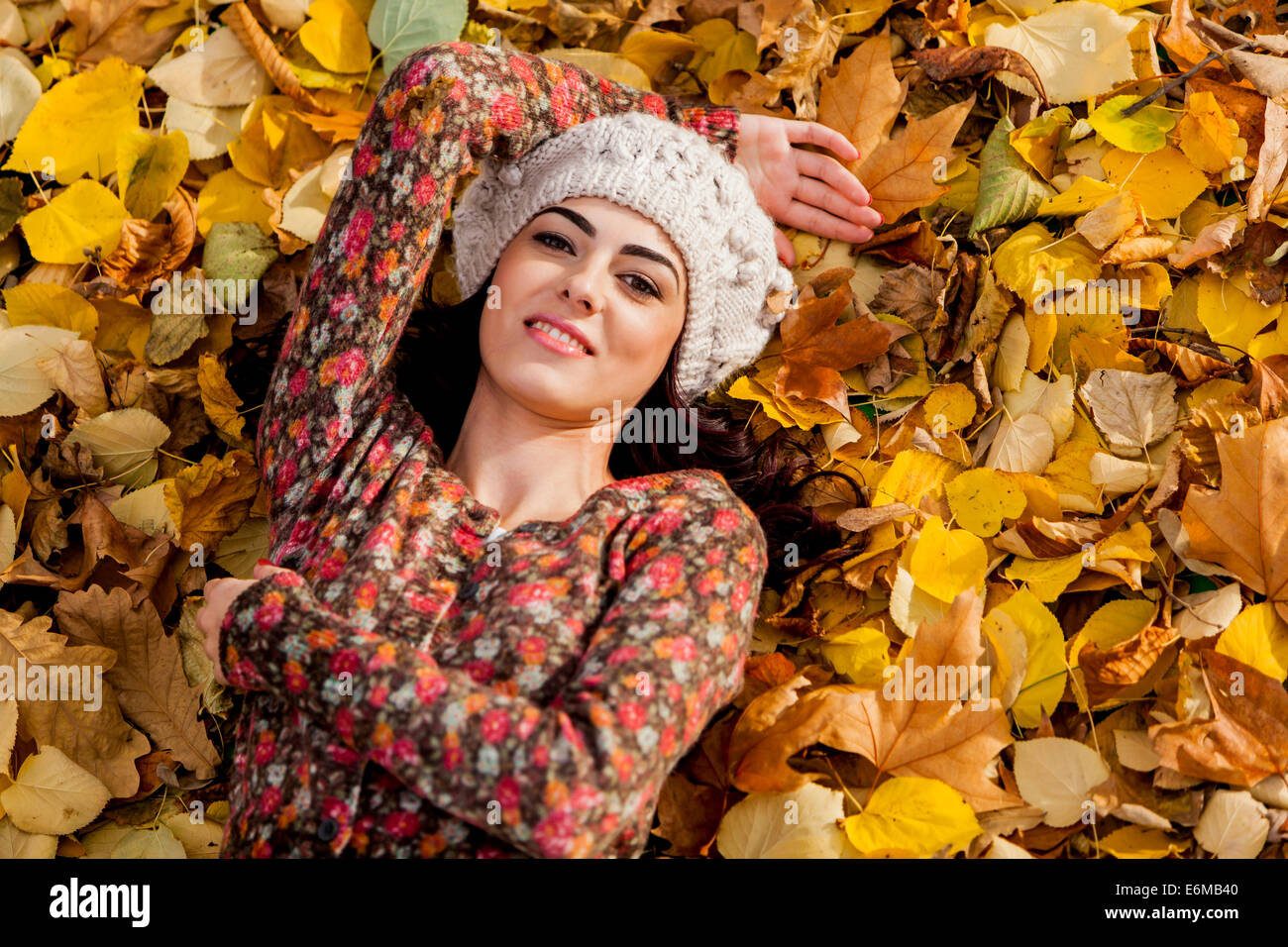 Young woman lying on leaves Stock Photo - Alamy