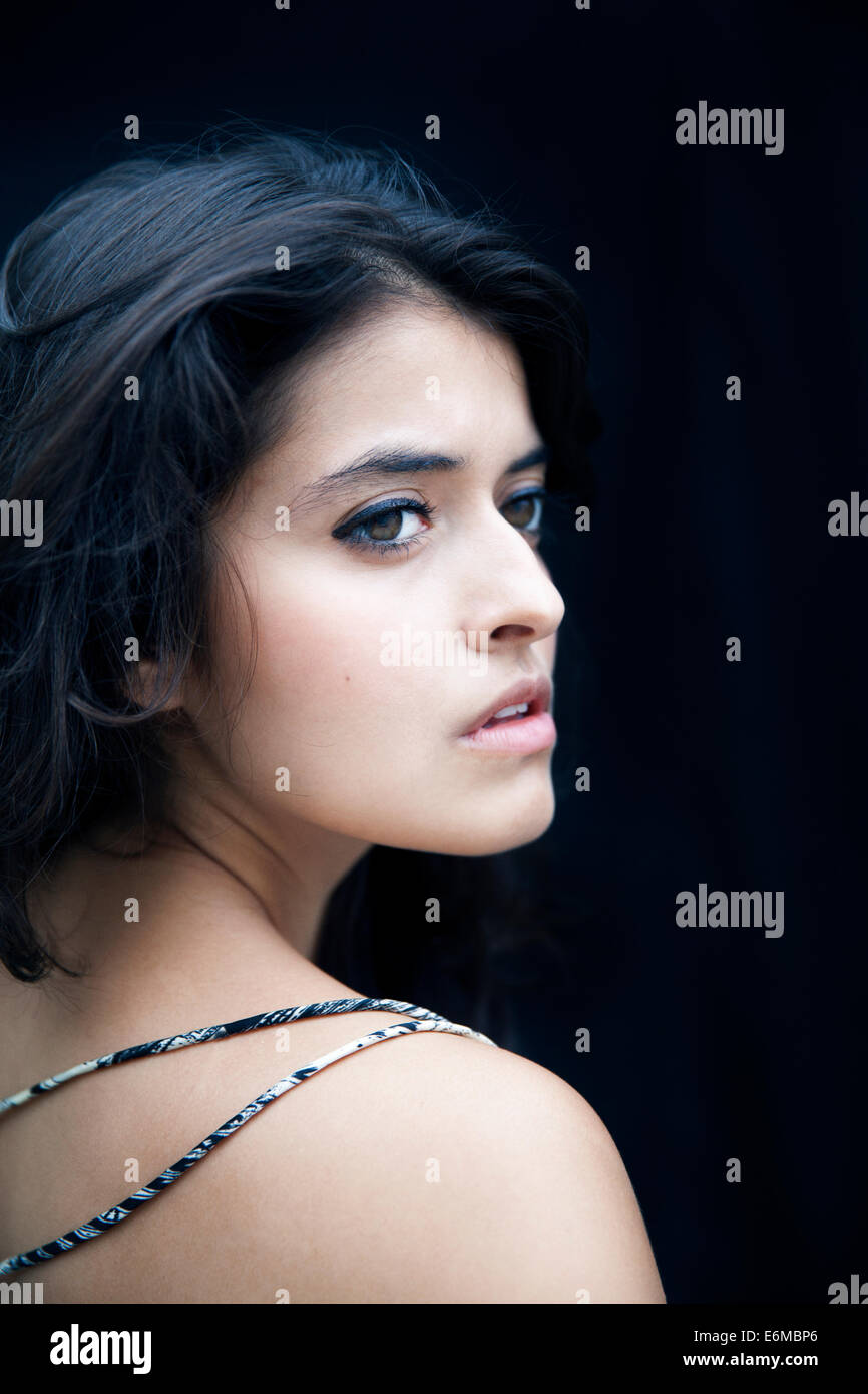 Young woman on black background Stock Photo - Alamy