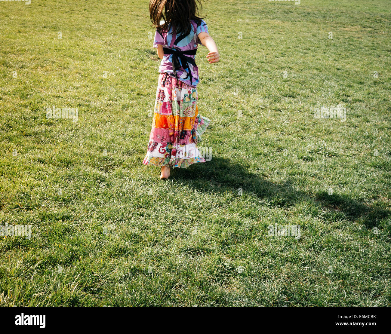 Girl running in field Stock Photo