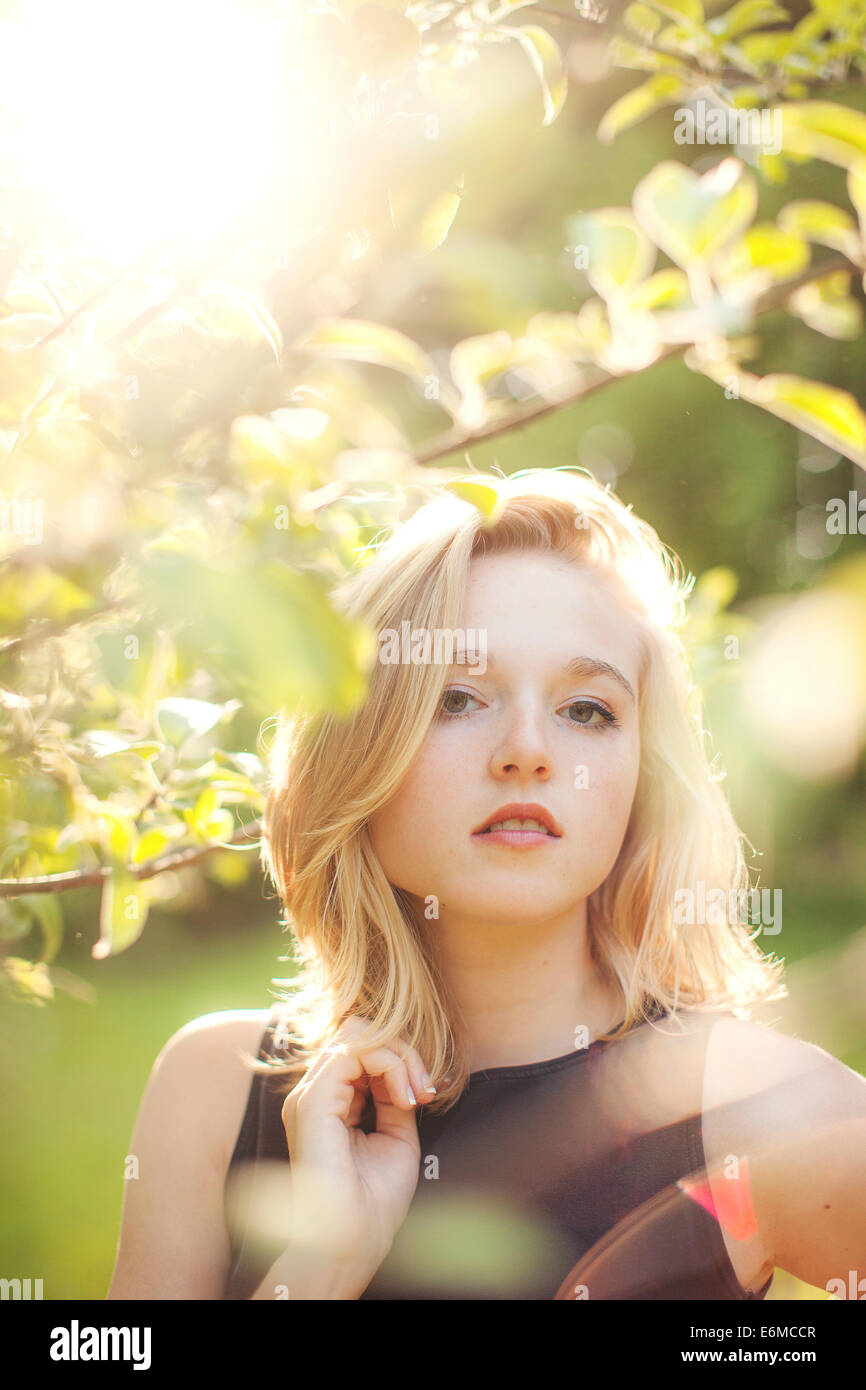 Portrait of young woman in forest Stock Photo - Alamy