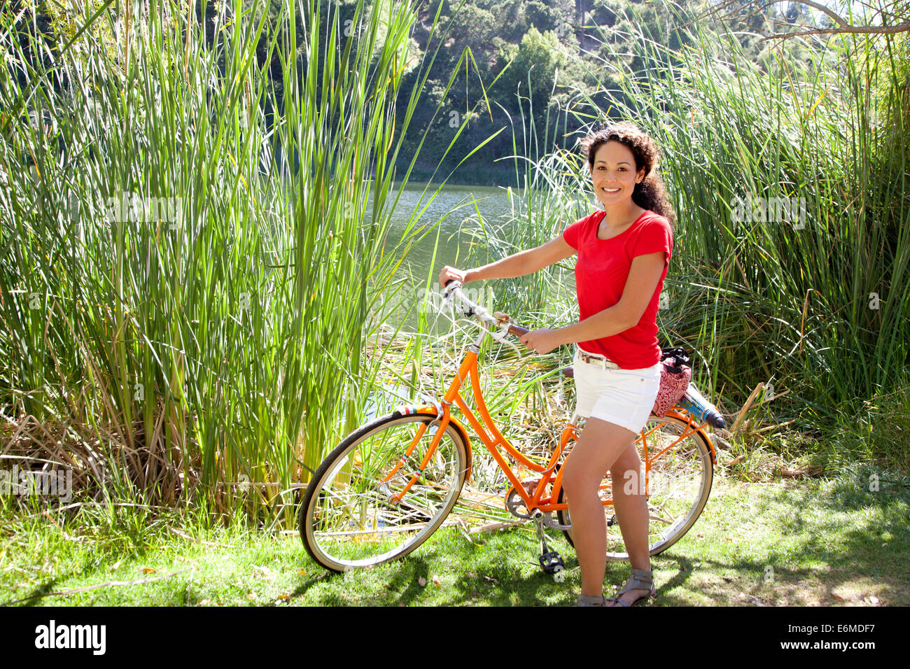 Portrait of woman with bicycle Stock Photo