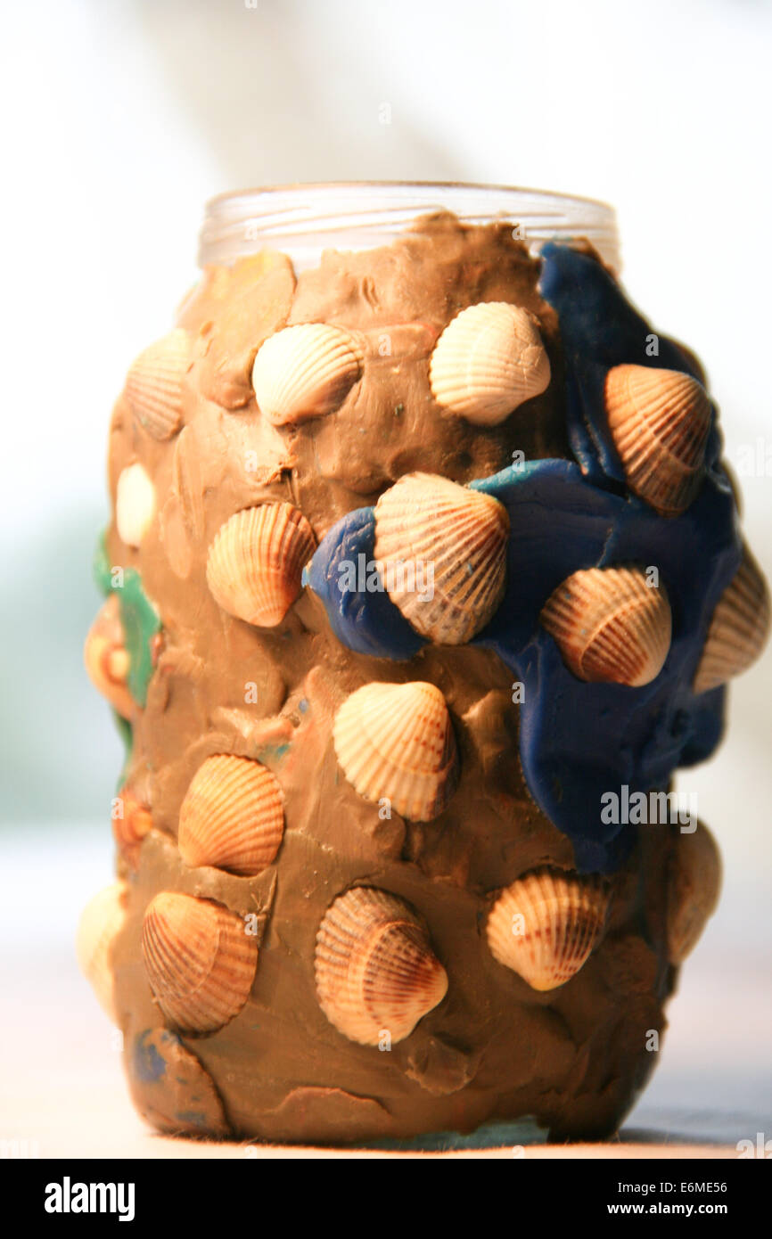Children handicraft made of seashells, plasticine and glass jar Stock Photo