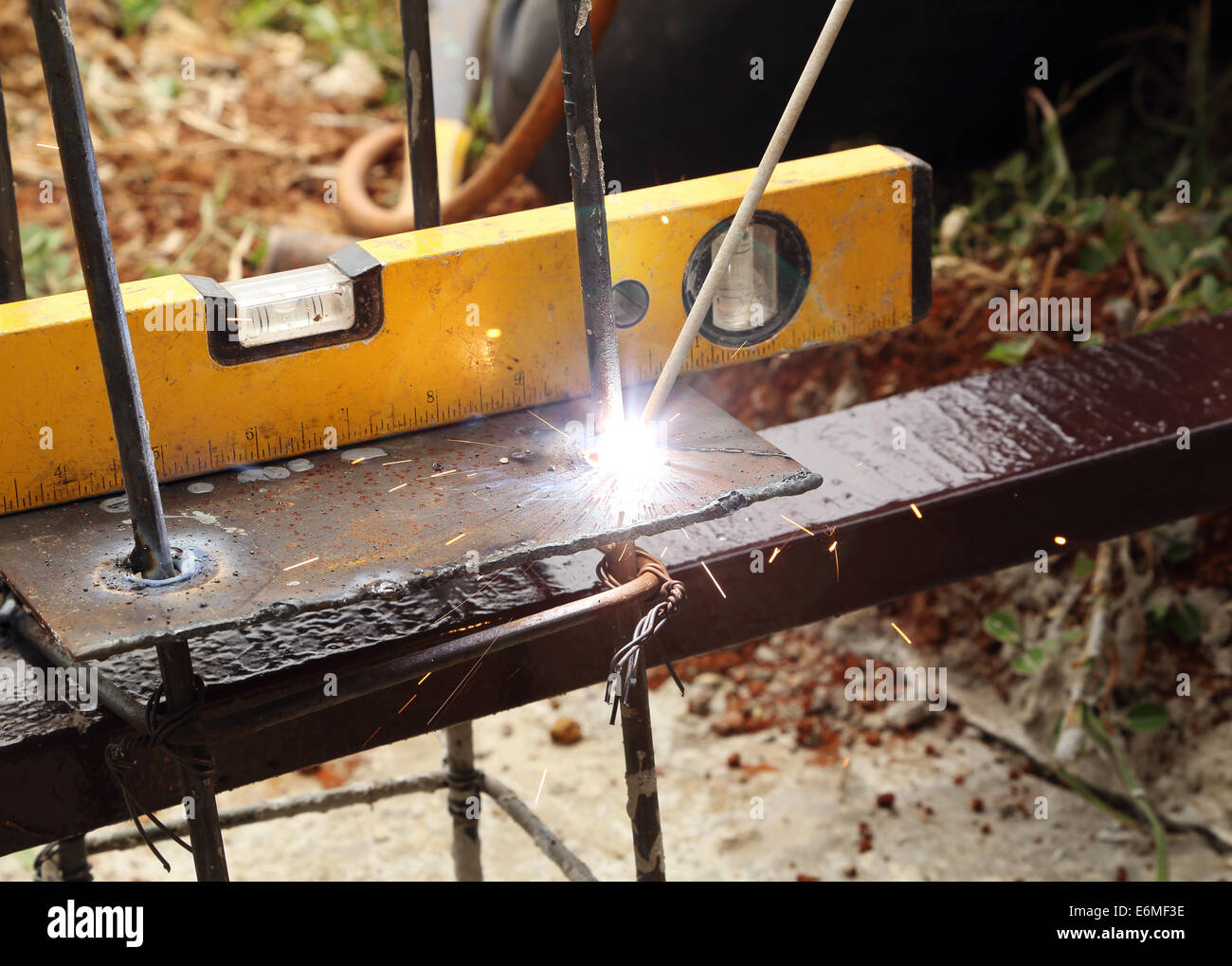 electric welding connecting metal rod and metal plate Stock Photo Alamy