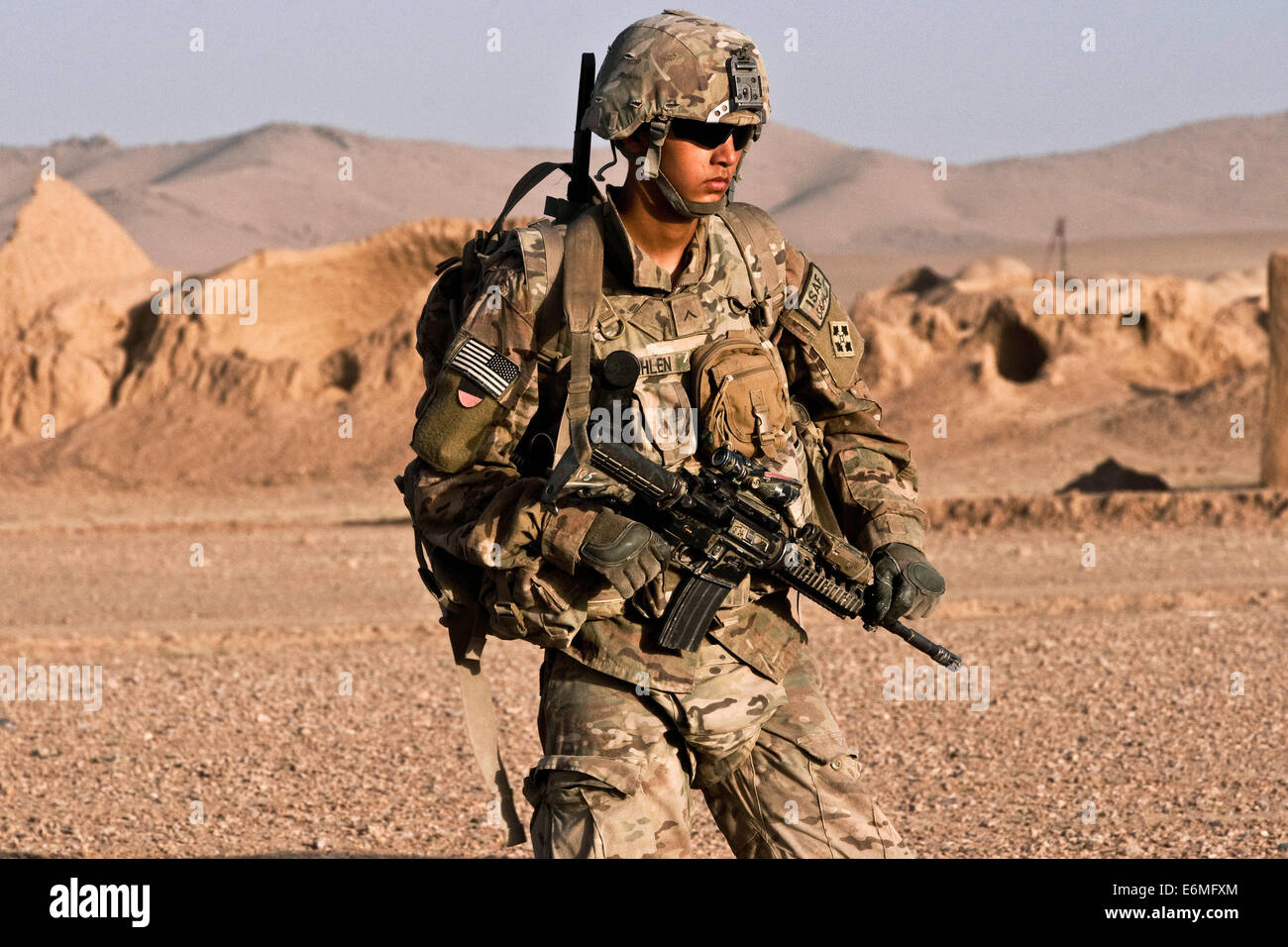 A US Army soldier on combat patrol in a village August 18, 2014 in Morghan Kachah, Kandahar Province, Afghanistan. Stock Photo