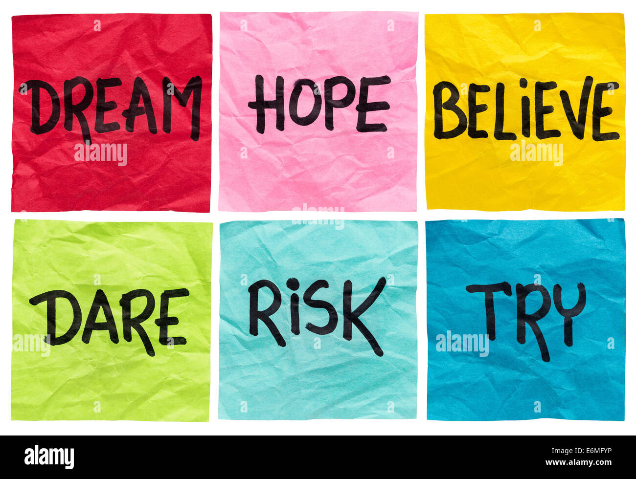 dream, hope, believe, dare, risk, try - motivational concept - a set of isolated crumpled sticky notes with handwritten advice a Stock Photo