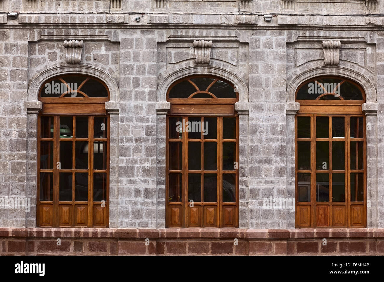 AMBATO, ECUADOR - JUNE 23, 2014: Windows of the building of the Instituto Tecnologico Superior Bolivar at Cevallos Park Stock Photo