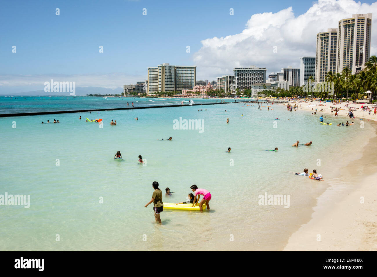 Honolulu Waikiki Beach Hawaii,Hawaiian,Oahu,Kuhio Beach Park,Pacific Ocean,Sheraton,hotel,Hyatt Regency,waterfront,sunbathers,sand,city skyline,high r Stock Photo