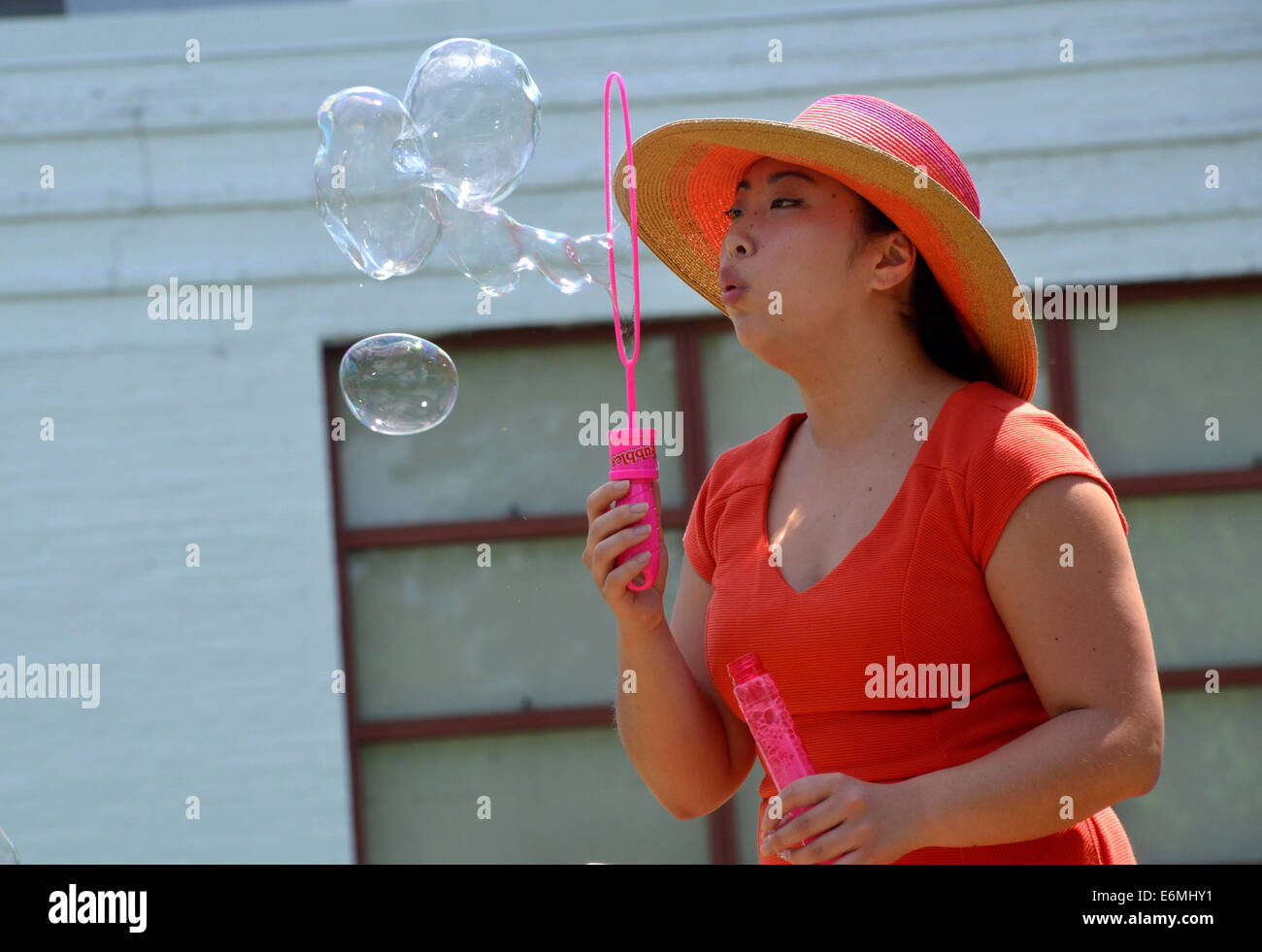 Woman blowing bubbles Stock Photo
