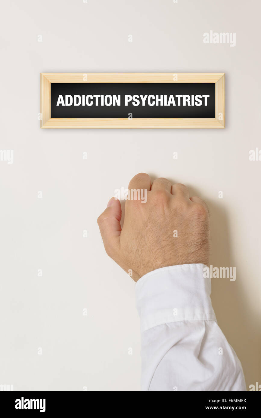 Male Patient knocking on Addiction Psychiatrist door for a specialist medical exam and help Stock Photo