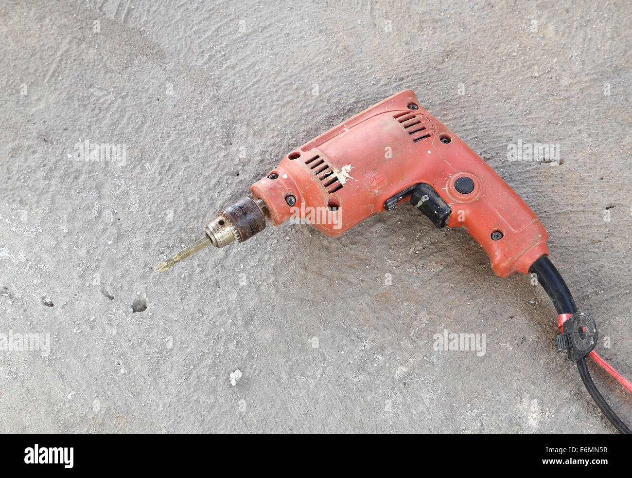 old drill with concrete Stock Photo Alamy