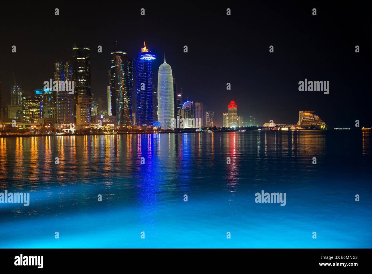 Night scene of the skyline of Doha with Al Bidda Tower, World Trade Center, Palm Tower 1 and 2, Burj Qatar Tower, Doha Corniche Stock Photo