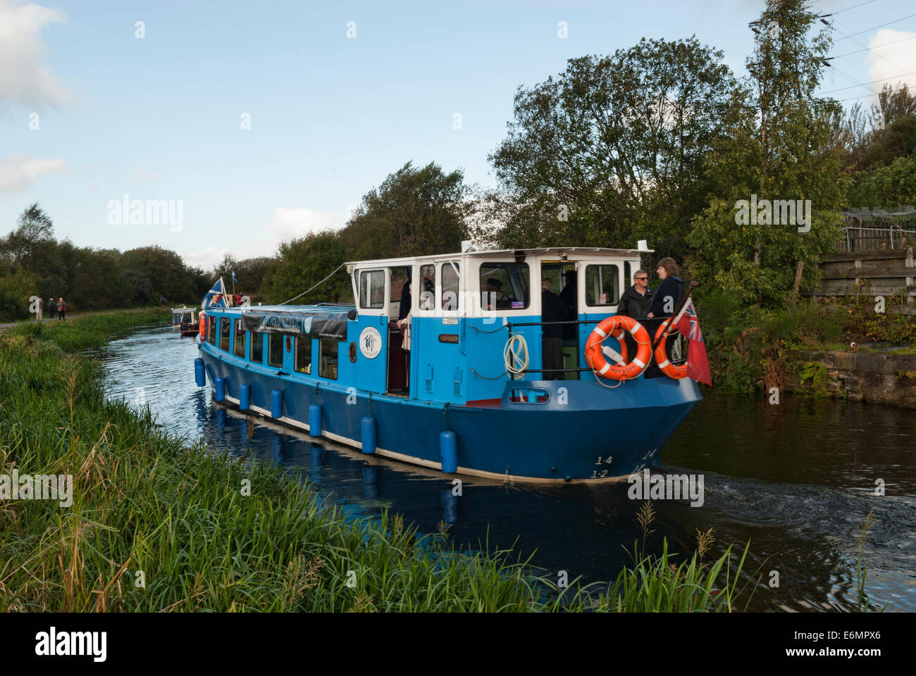 Canal narrowboat sailing as part of a flotilla on the Forth & Clyde Canal. Stock Photo