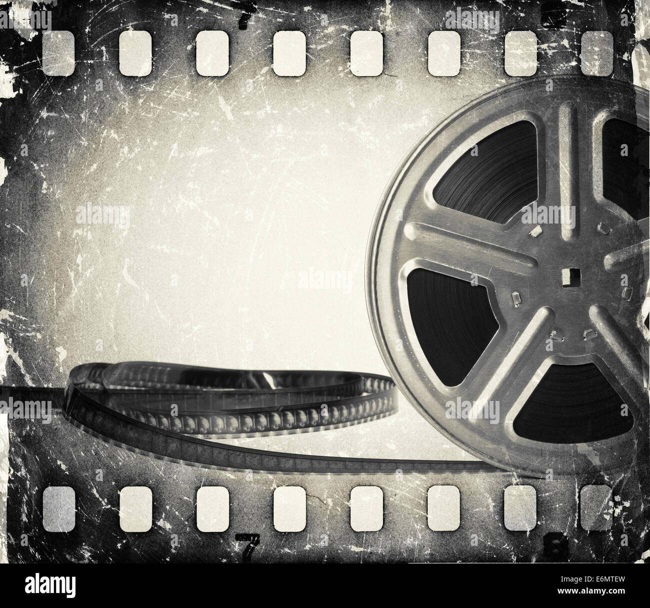 Grunge old motion picture film reel with film strip. Vintage