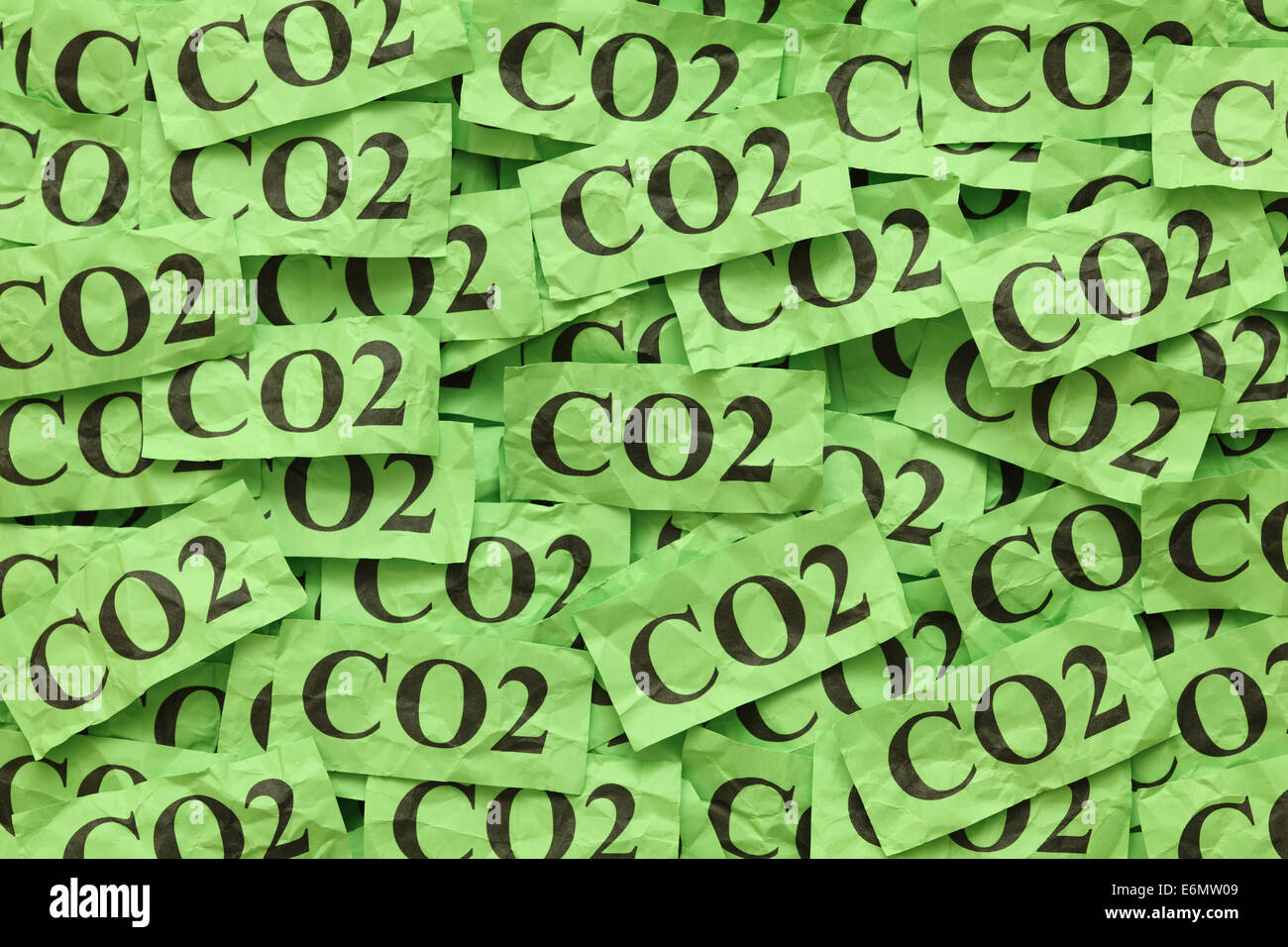 Pile of green paper notes with word 'CO2' (Carbon Dioxide). Stock Photo