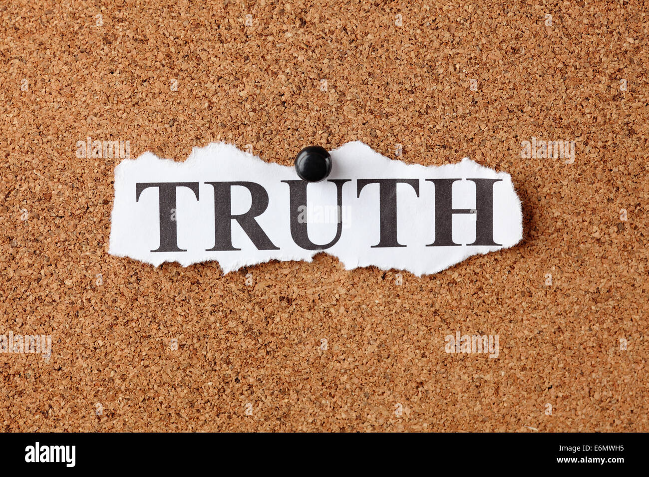 Torn piece of paper with the word 'Truth' on cork board (bulletin board). Stock Photo