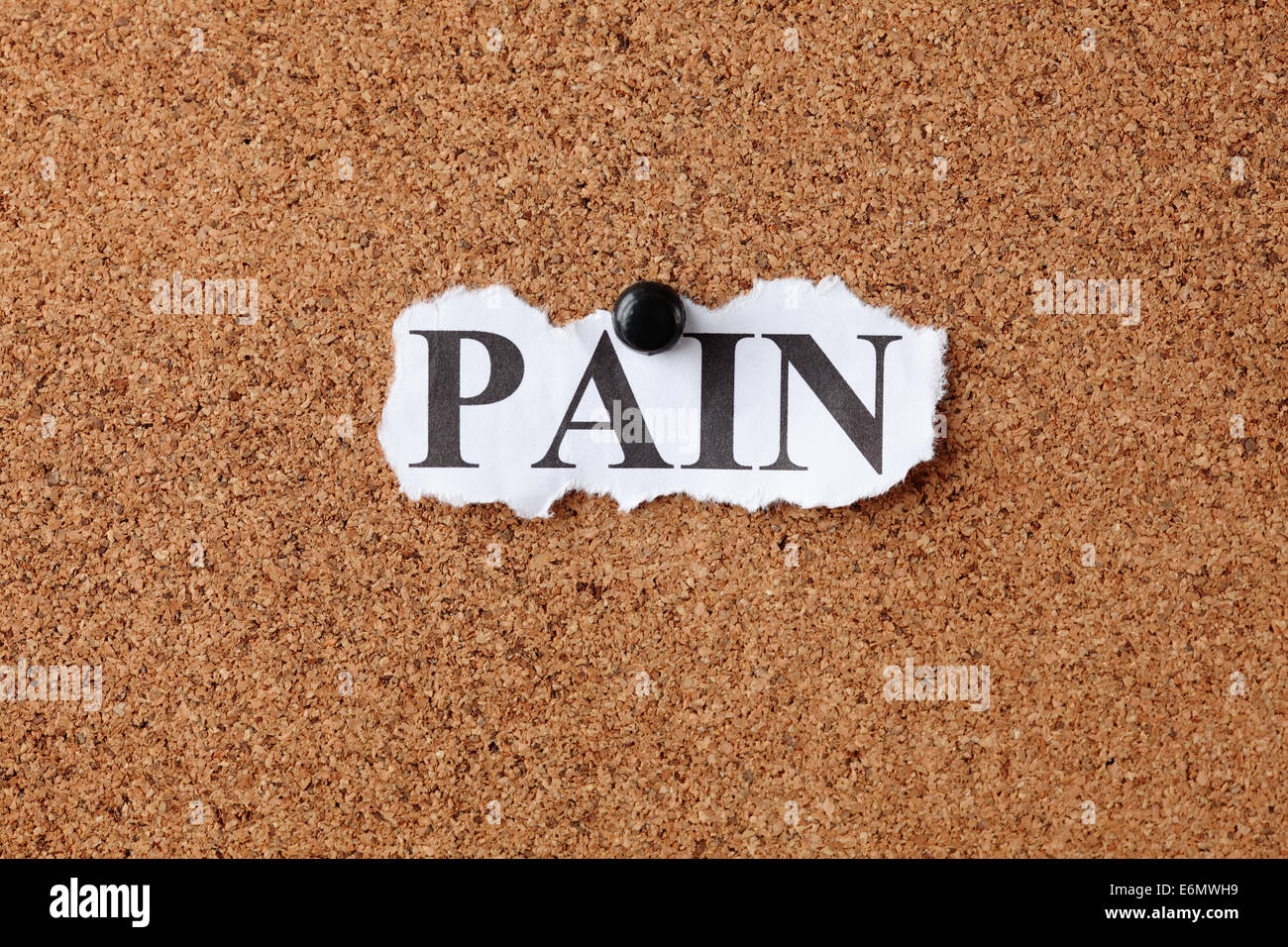 Torn piece of paper with the word 'Pain' on cork board (bulletin board) Stock Photo