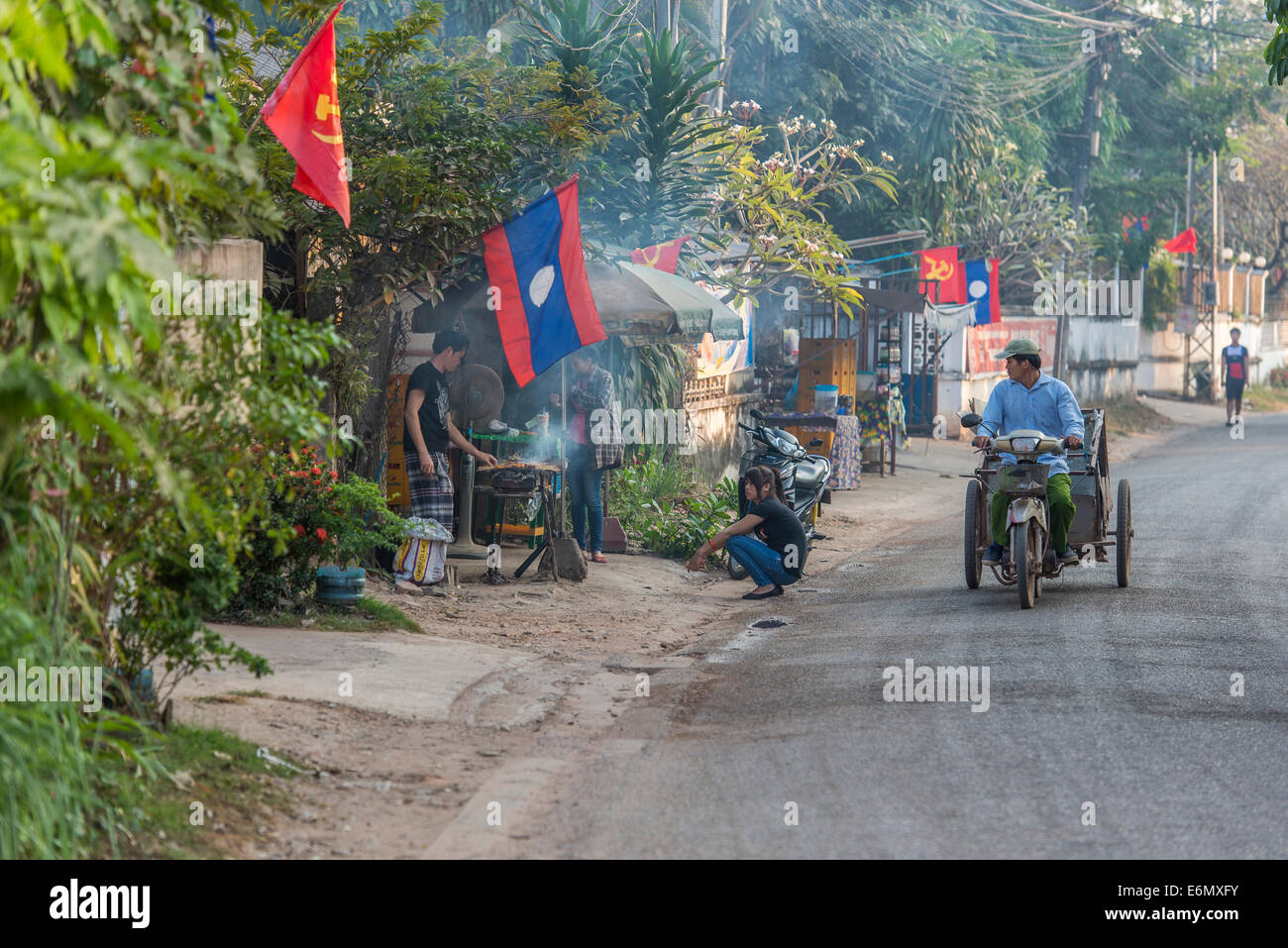 Evenig street scene Vientiane Laos [Lao PDR] [communist flag] [Lao flag] [after work] [BBQ] Stock Photo