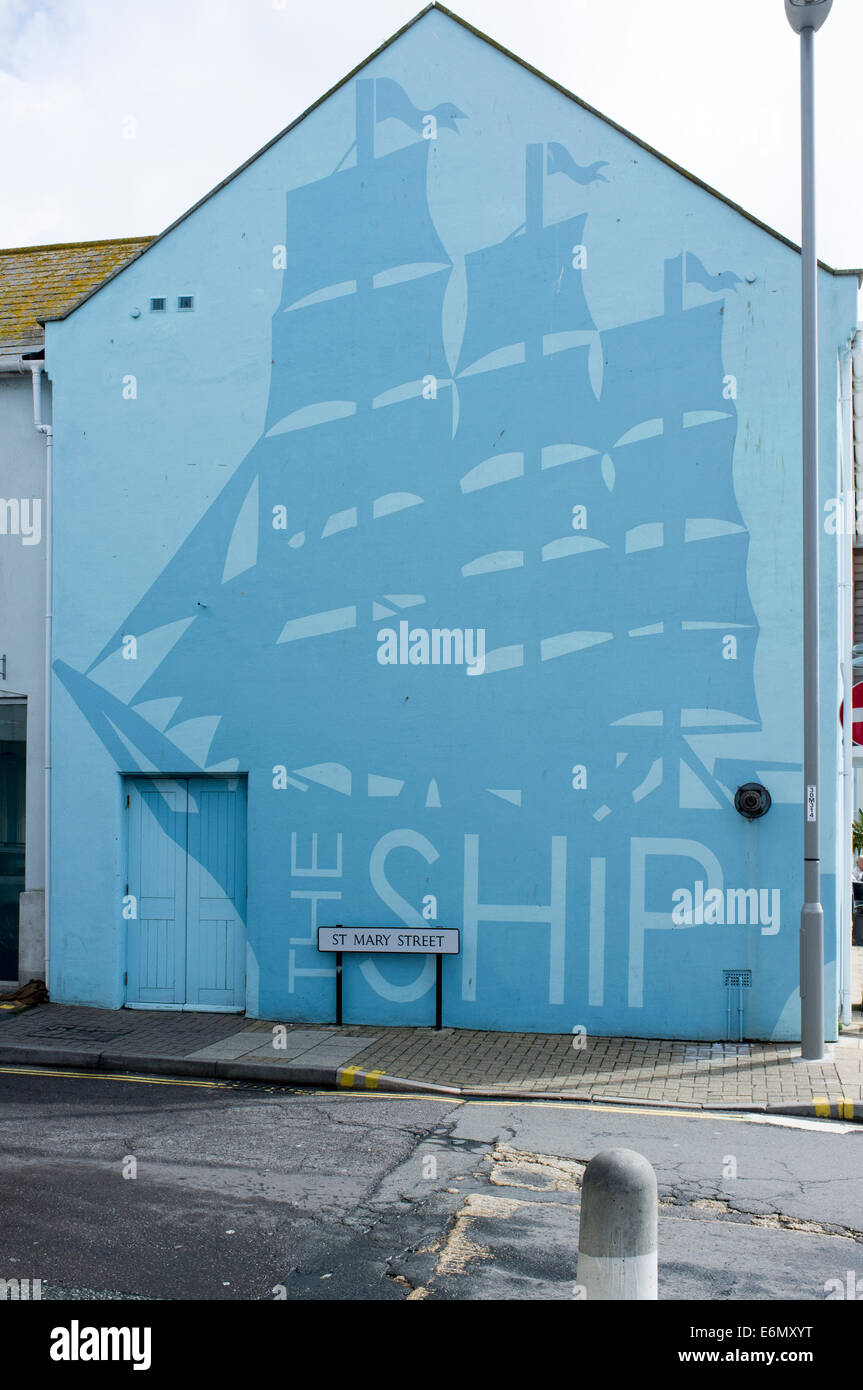 Large painted picture of a ship on the end wall of a UK pub called The