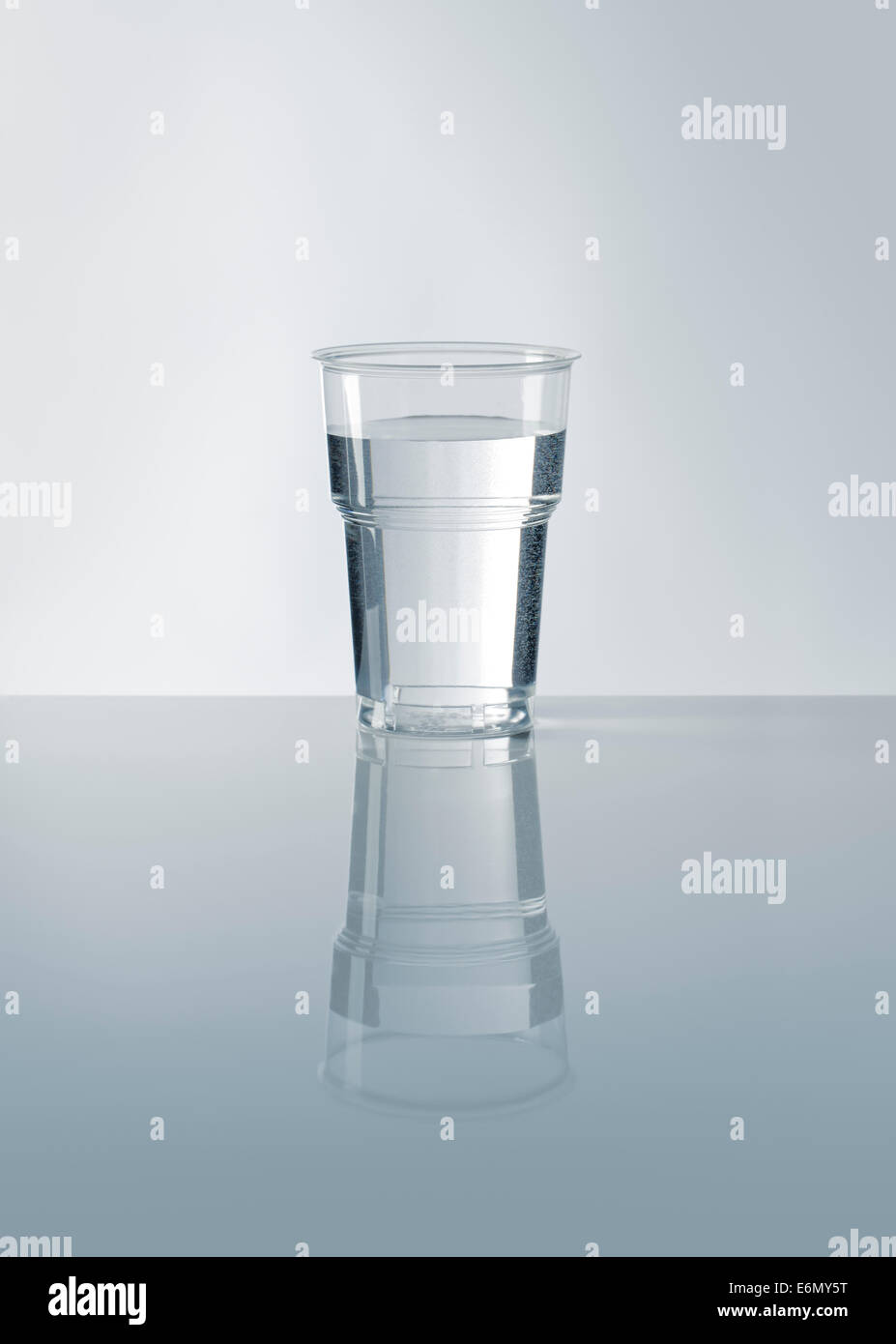 A Disposable plastic cup filled with water. Stock Photo