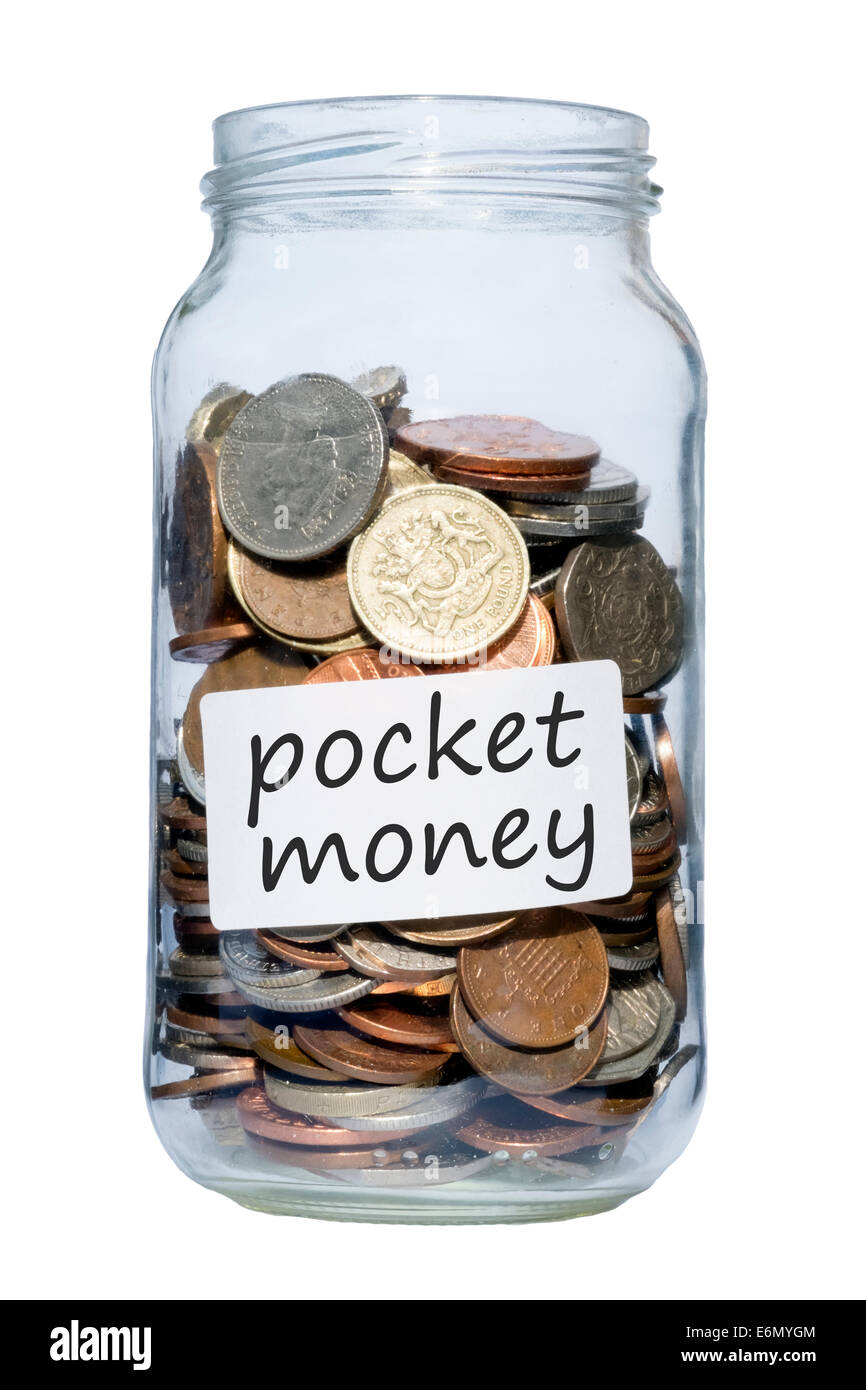 Jam jar full of coins, UK. Glass jar containing pounds & pennies savings. Stock Photo