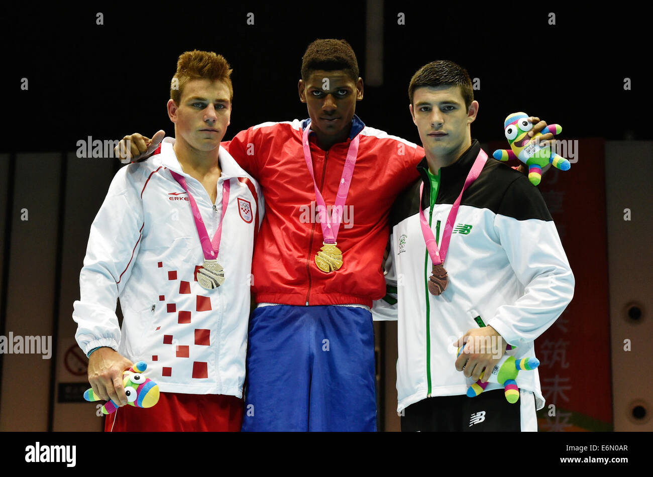 Nanjing, China's Jiangsu Province. 27th Aug, 2014. Gold medalist Alain Hernandez Morejon Yordan of Cuba, silver medalist Toni Filipi of Croatia and bronze medalist Michael Gallagher of Ireland pose for photo during the awarding ceremony of men's heavy (91kg) final bout of boxing at the Nanjing 2014 Youth Olympic Games in Nanjing, east China's Jiangsu Province, Aug. 27, 2014. Credit:  Ou Dongqu/Xinhua/Alamy Live News Stock Photo