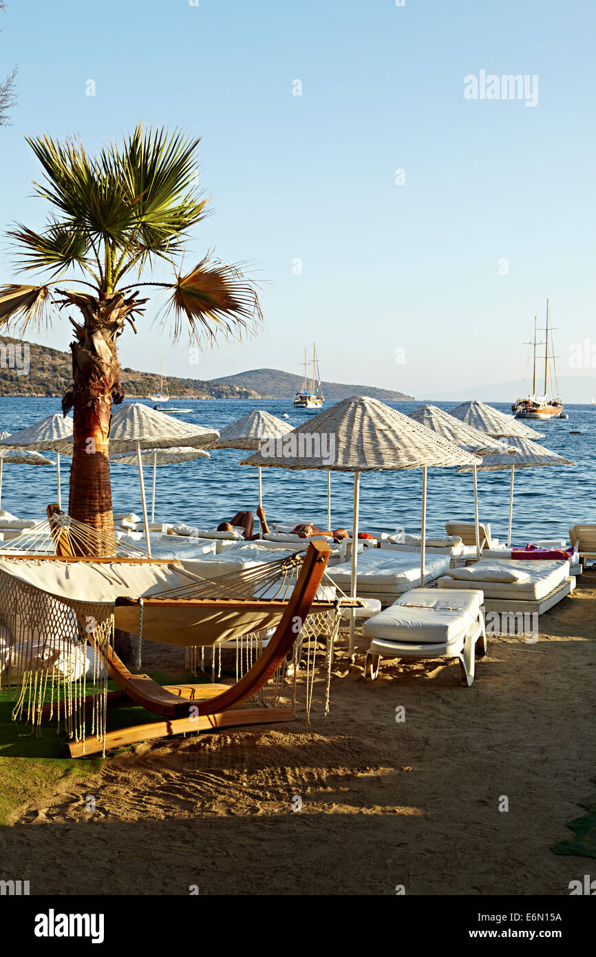 Hammock on beach with white umbrellas and sunbeds, Bitez, Turkey, Stock Photo