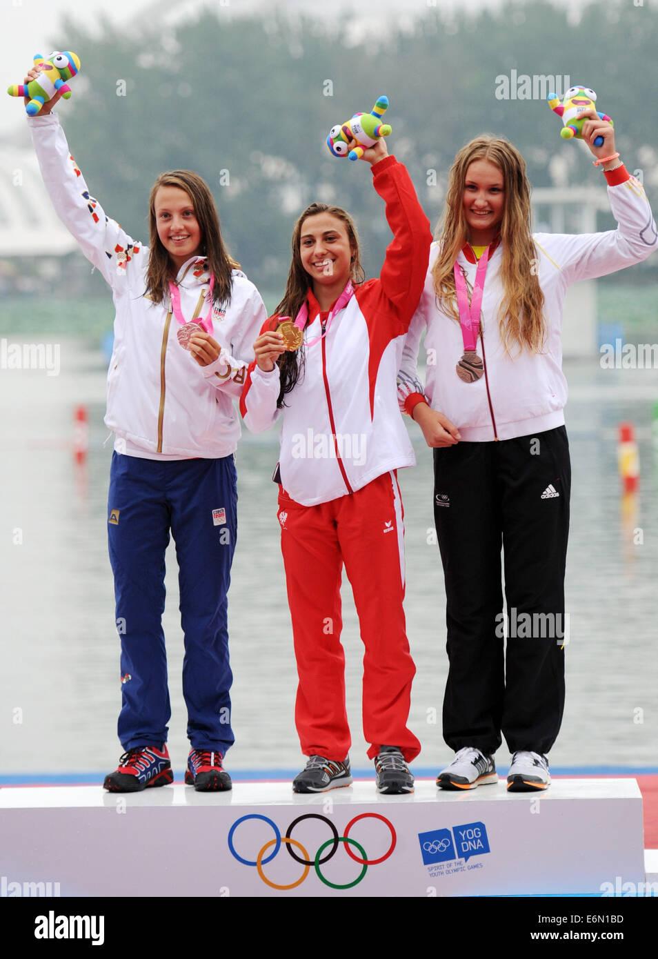 Nanjing, China's Jiangsu Province. 27th Aug, 2014. Gold medalist Nadine Weratschnig(C) of Austria, silver medalist Martina Satkova(L) of Czech Republic and bronze medalist Birgit Ohmayer of Germany pose on the podium during the awarding ceremony for the women's C1 obstacle canoe slalom of Canoe-Kayak event during Nanjing 2014 Youth Olympic Games in Nanjing, capital of east China's Jiangsu Province, on Aug. 27, 2014. Credit:  Chen Yehua/Xinhua/Alamy Live News Stock Photo