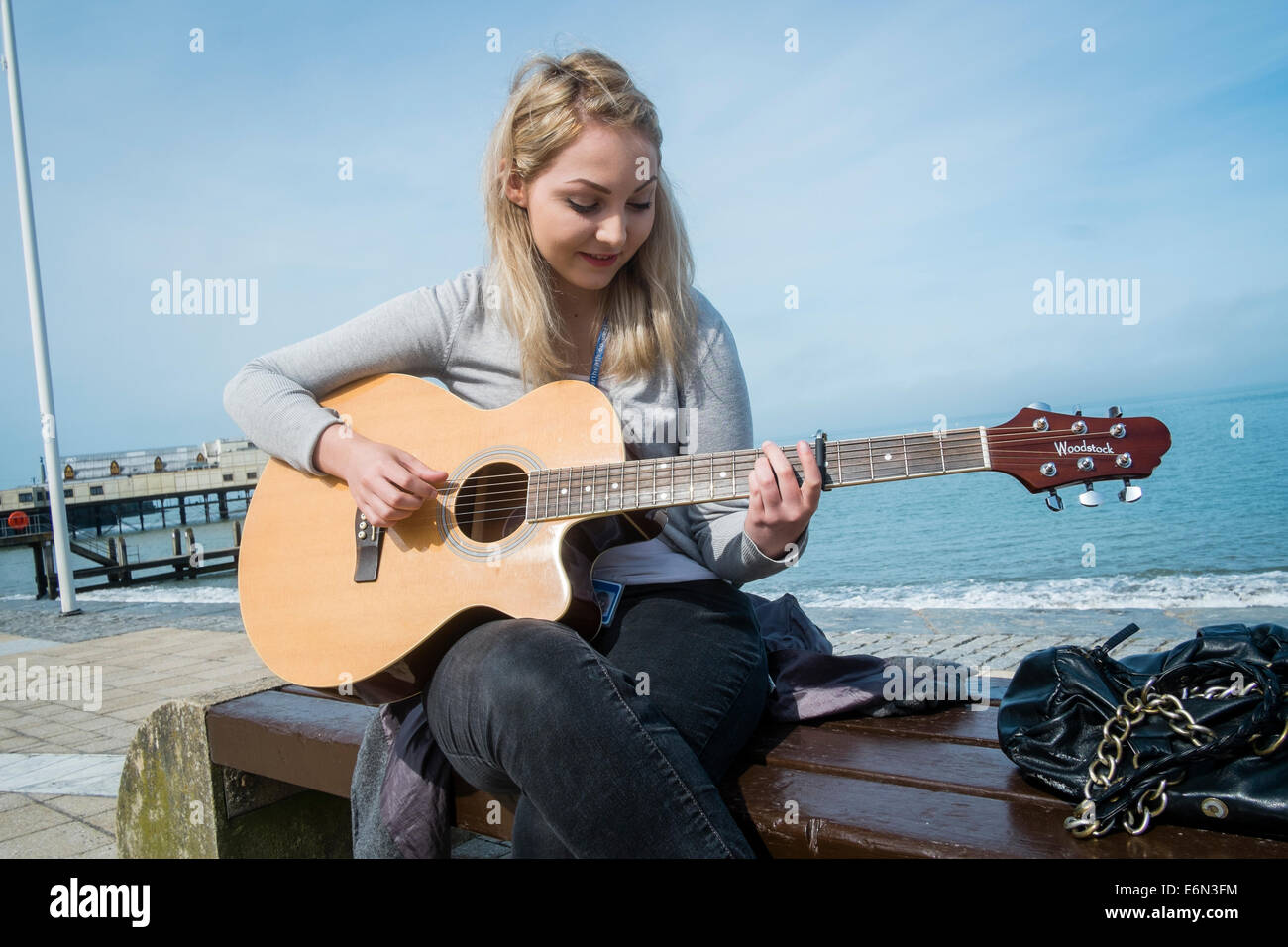 NIAMH MANLEY, a young woman busking on the seafront in Aberystwyth Wales UK Stock Photo