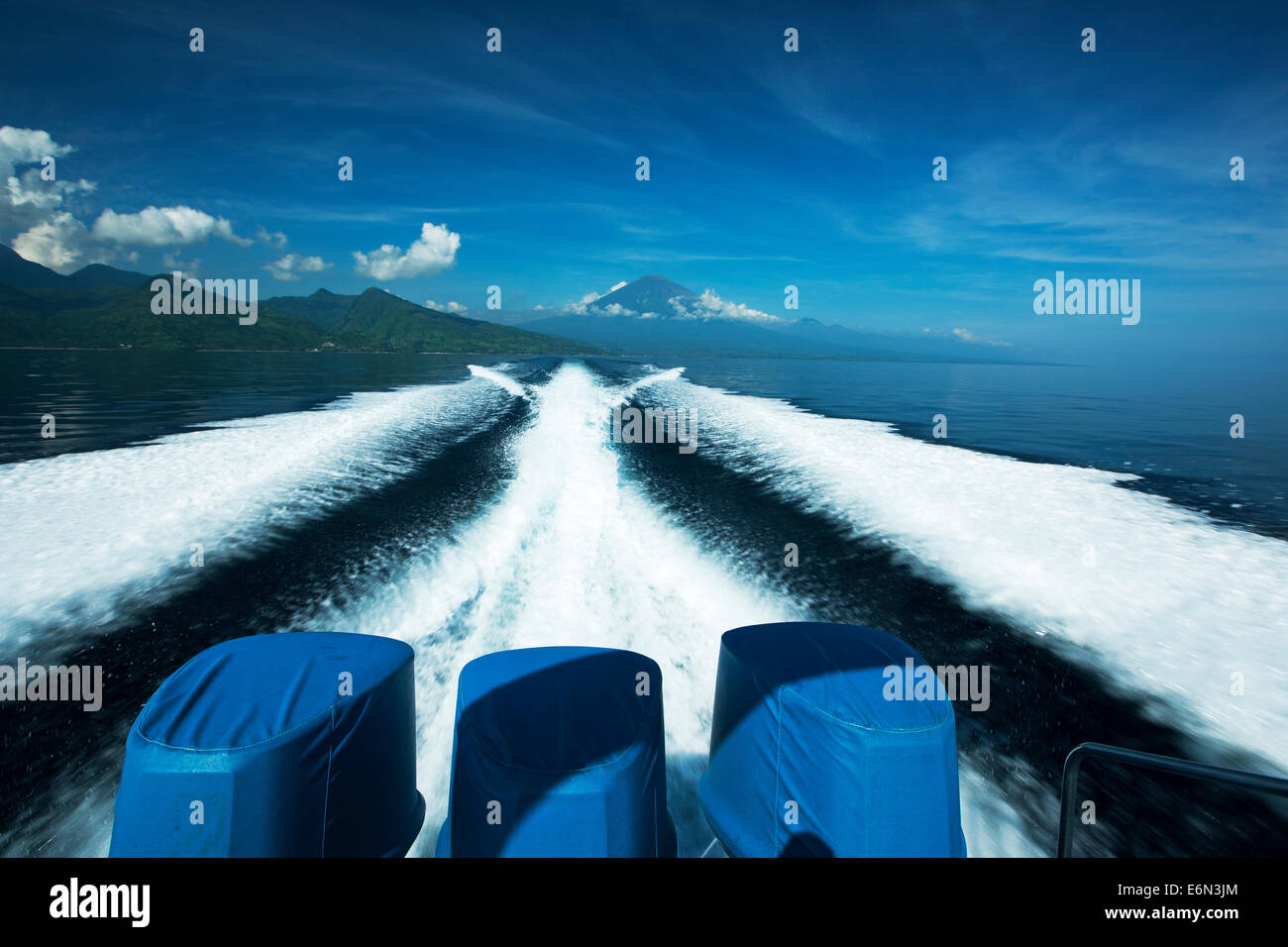 Seed boat traveling to Gili Islands from Bali with Mount Agung in back ground. Stock Photo