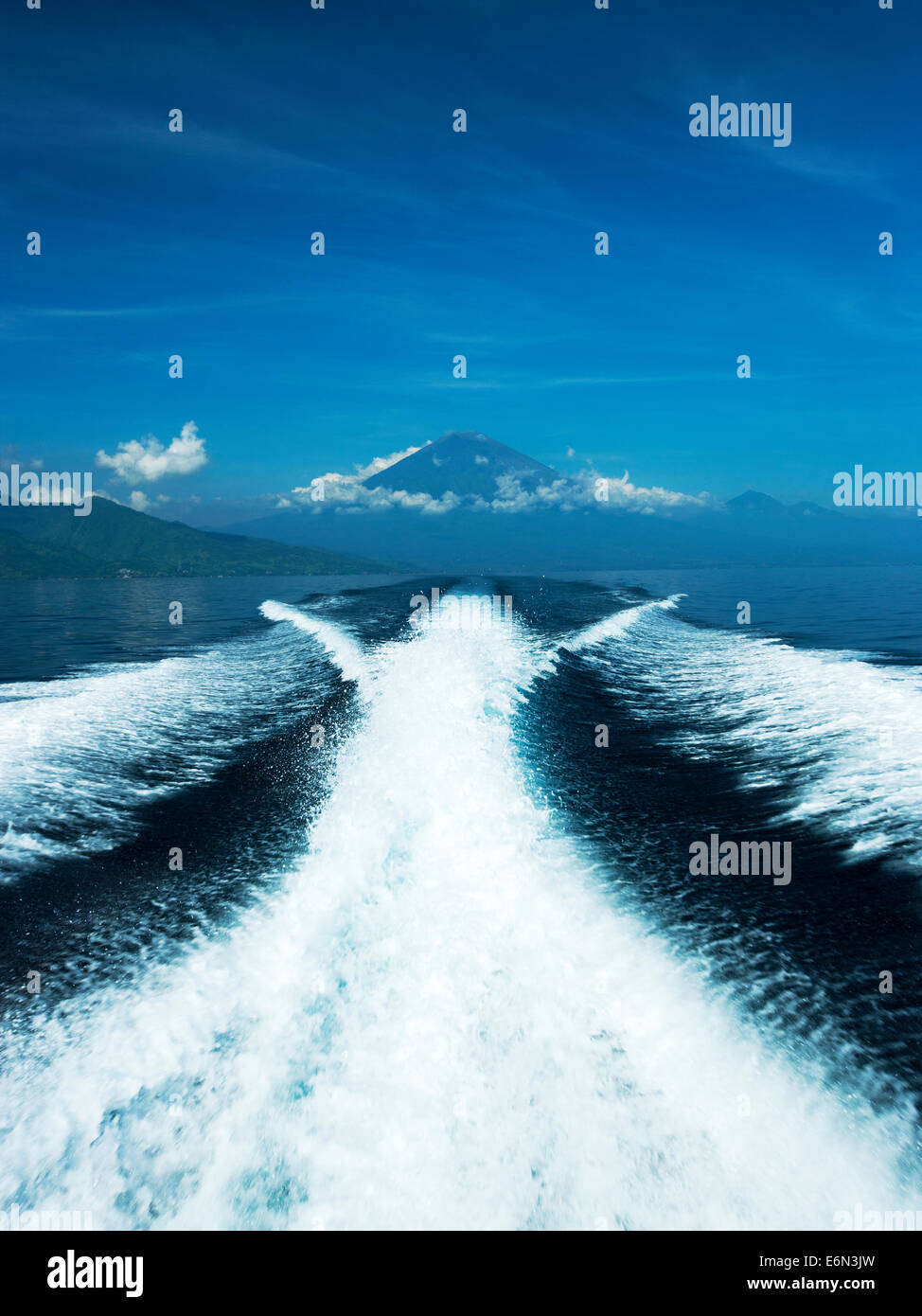 Speed boat from  Bali to the Gili Islands with Mount Agung in the back ground. Stock Photo